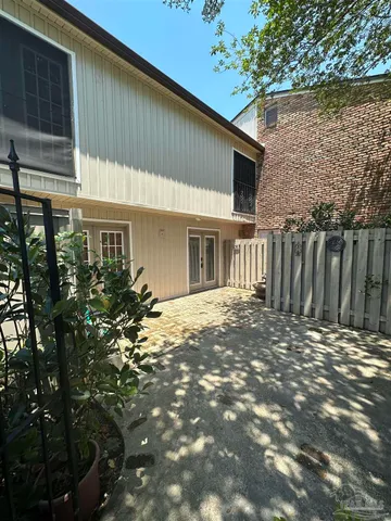 a backyard of a house with table and chairs