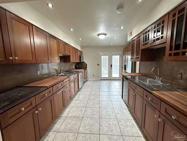 a large kitchen with stainless steel appliances granite countertop lots of counter top space