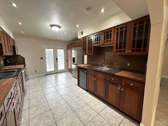 a kitchen with stainless steel appliances granite countertop a stove and a sink