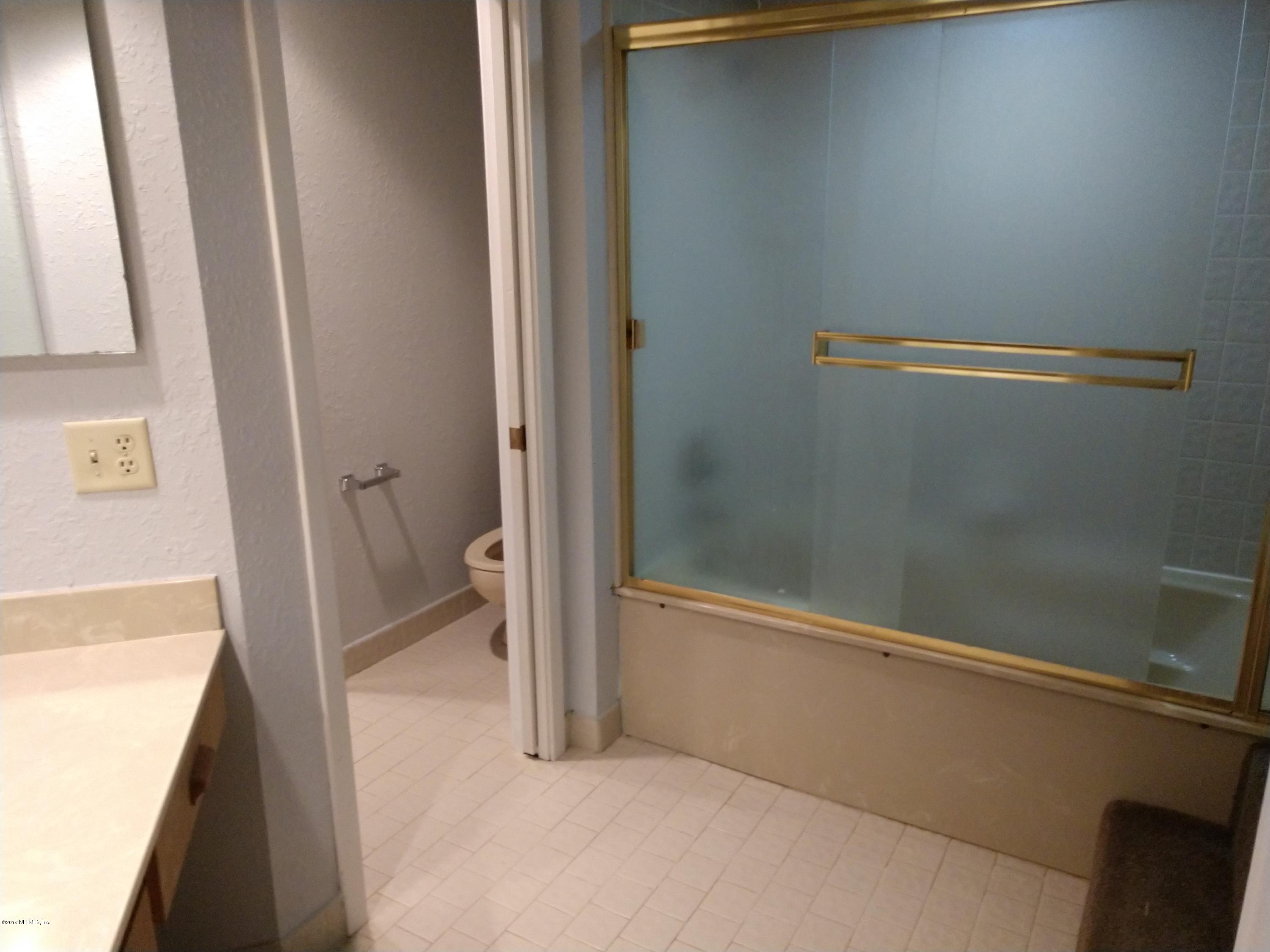 3155 Ravines Road, Unit 3527 Middleburg, FL 32068 - Photo 5 of 13 a bathroom with a bathtub and a shower