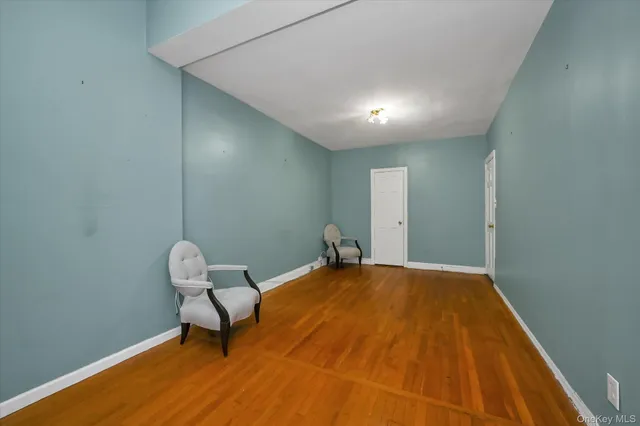 a view of a room with a bench and wooden floor