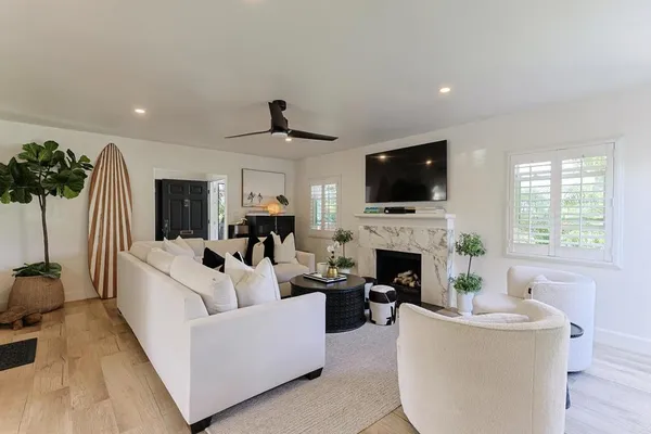 a living room with furniture a fireplace and a flat screen tv