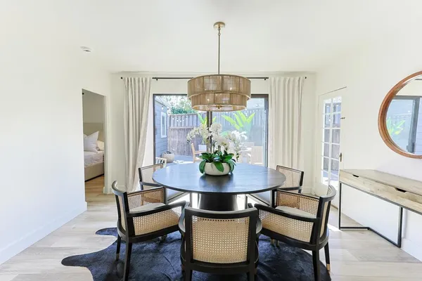 a living room with furniture a chandelier and a window