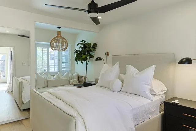 a bedroom with a bed potted plant with the window