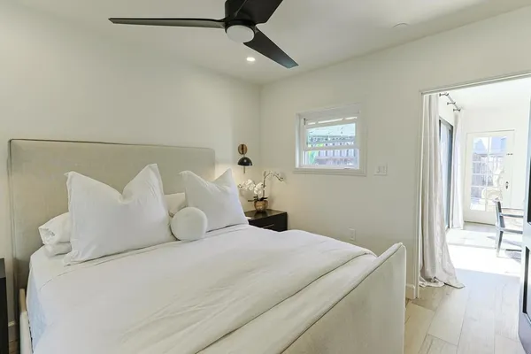 a bedroom with a bed and a lamp