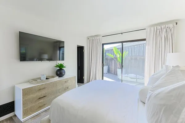 a view of a patio with table and chairs and potted plants