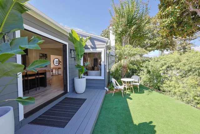 a view of a house with backyard sitting area and garden