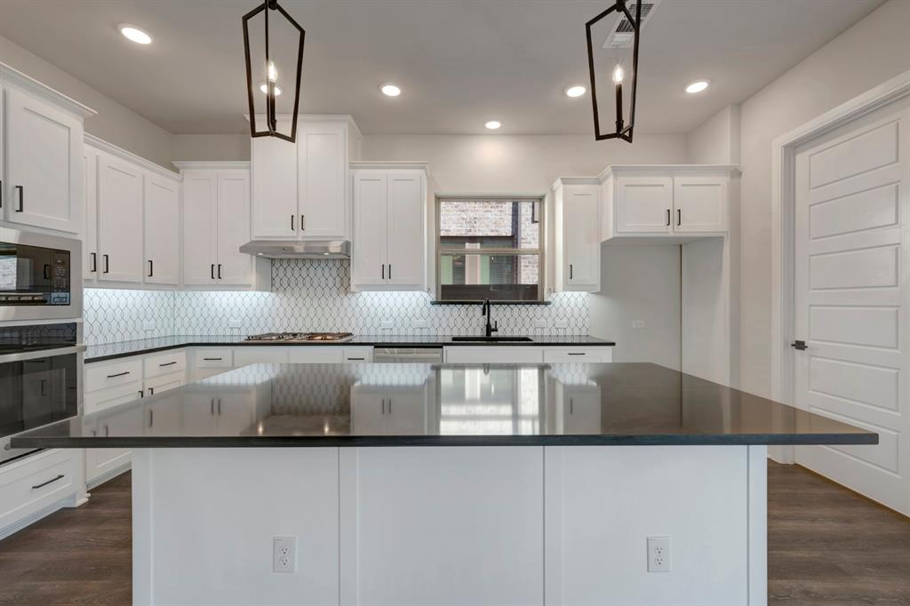 1857 Lightner Road Van Alstyne, TX 75495 - Photo 15 of 29 a large kitchen with granite countertop a sink a counter space appliances and cabinets