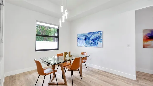 a dining room with furniture and window