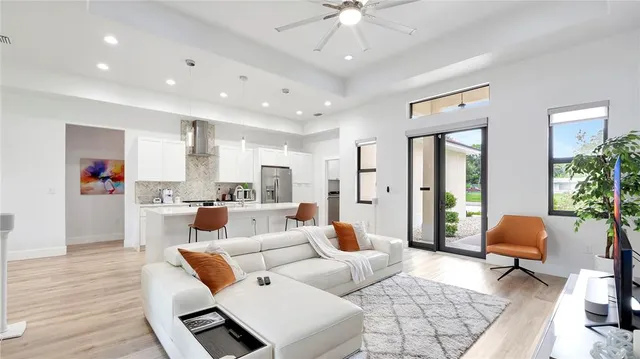a living room with furniture and a chandelier