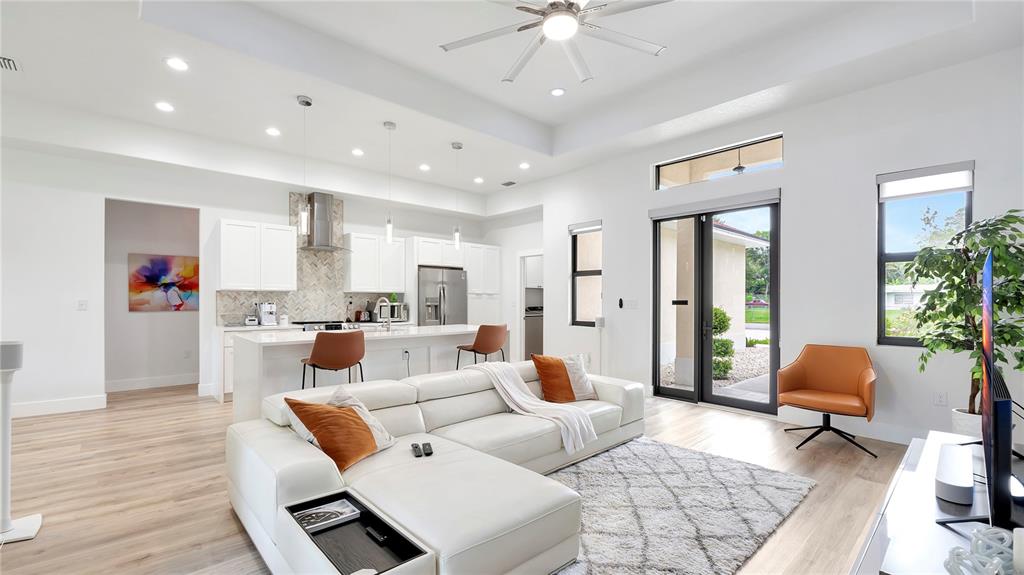 306 East Clay Avenue Brandon, FL 33510 - Photo 12 of 26 a living room with furniture and a chandelier