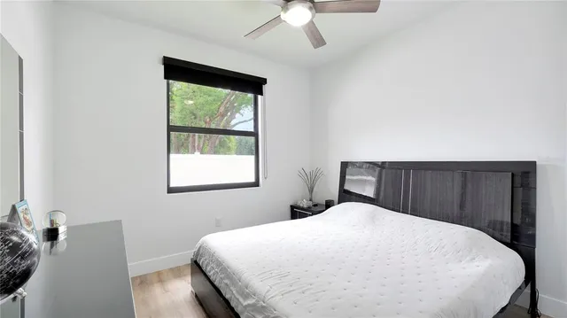 a bed sitting in a bedroom next to a window