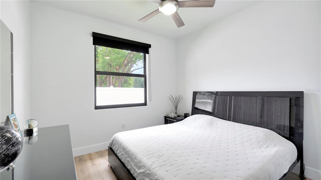 306 East Clay Avenue Brandon, FL 33510 - Photo 14 of 26 a bed sitting in a bedroom next to a window