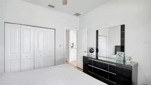 a bedroom with a bed and a mirror