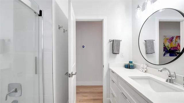 a bathroom with a sink mirror and vanity