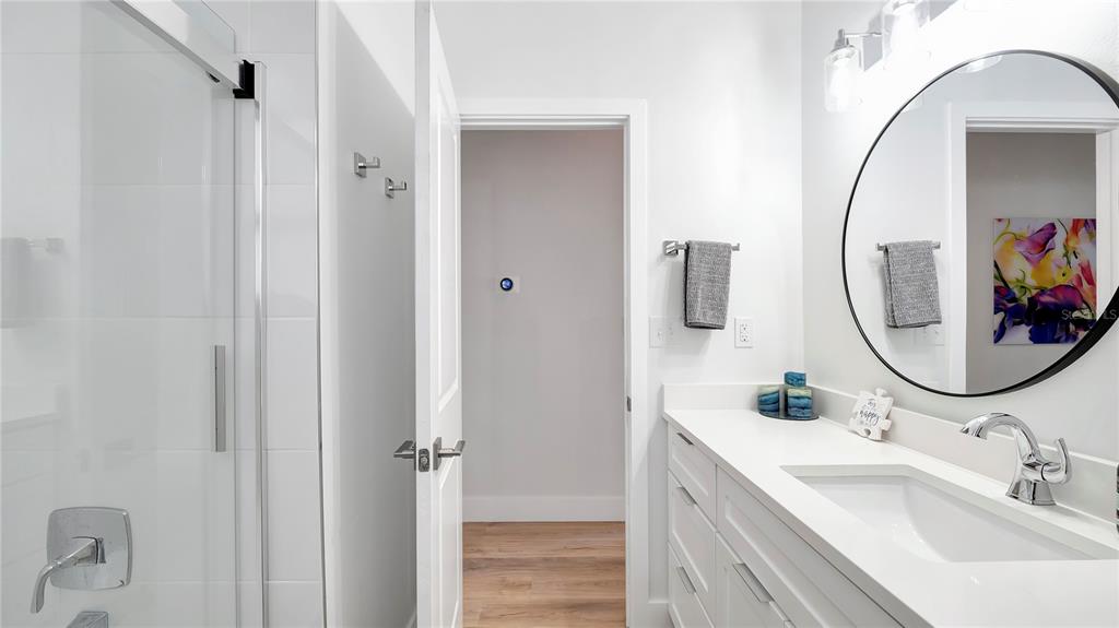 306 East Clay Avenue Brandon, FL 33510 - Photo 17 of 26 a bathroom with a sink mirror and vanity