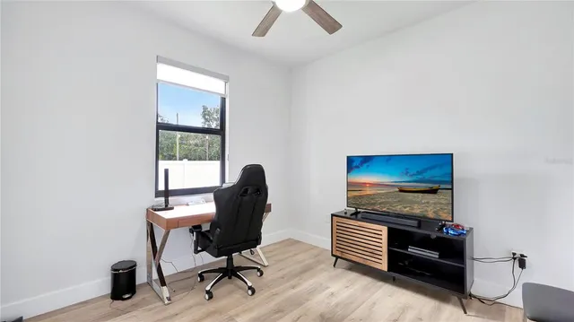 a view of a workspace with furniture and a window