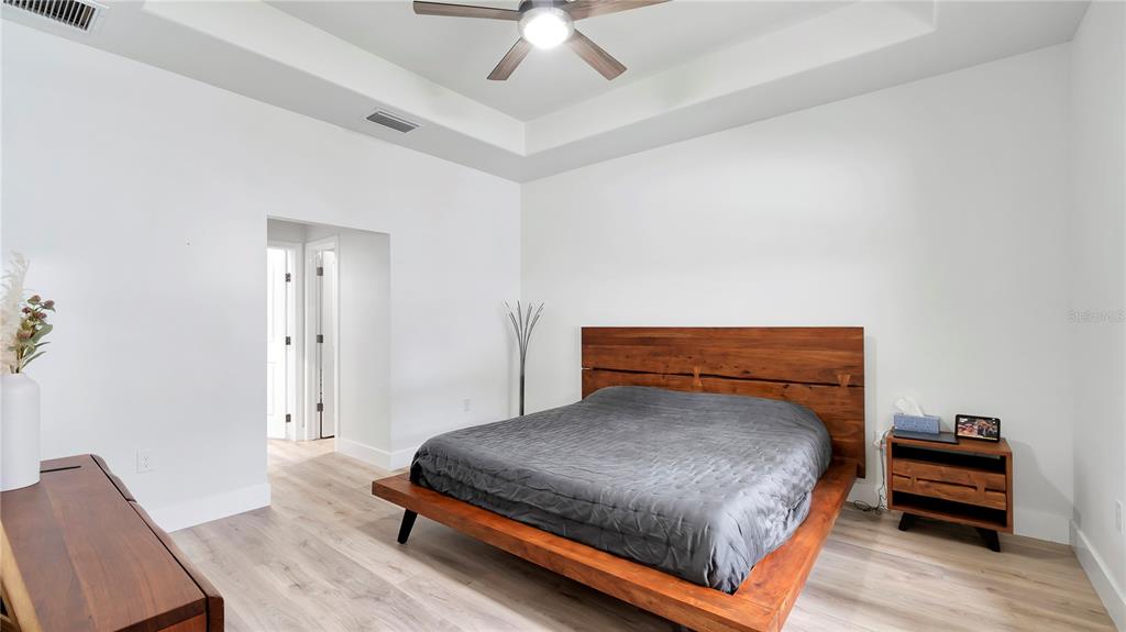 306 East Clay Avenue Brandon, FL 33510 - Photo 20 of 26 a bedroom with a bed and a chandelier