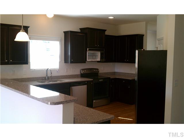 Beautiful kitchen with Expresso cabinets, Granite and Hardwoods! Great for entertaining with the extended bartop!