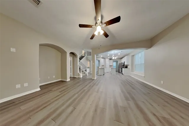 a view of empty room with wooden floor