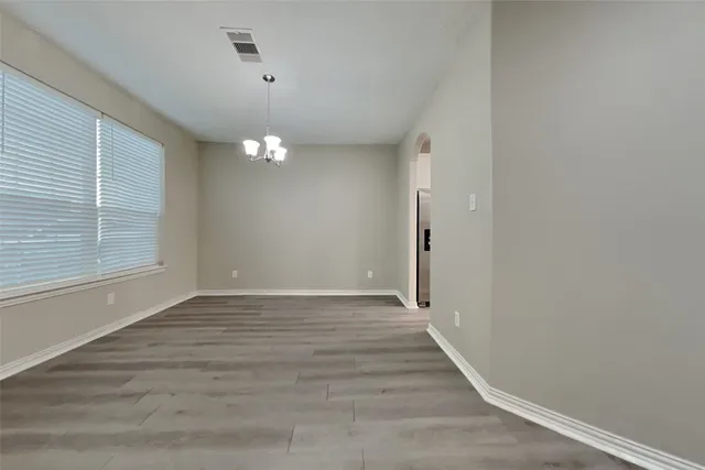 a view of a room with wooden floor and window