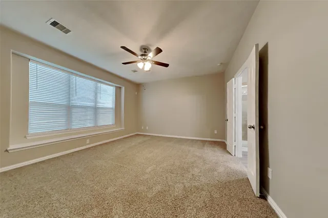 an empty room with a empty space and windows