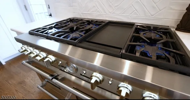 a kitchen with a refrigerator sink and cabinets