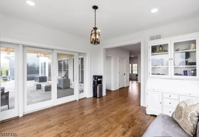 a view of a patio with chairs and floor to ceiling window