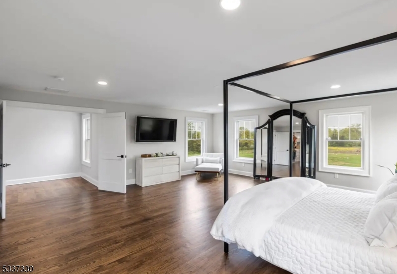 134 Hillsborough Road Hillsborough, NJ 08844 - Photo 23 of 50 a spacious bedroom with a bed and a flat screen tv