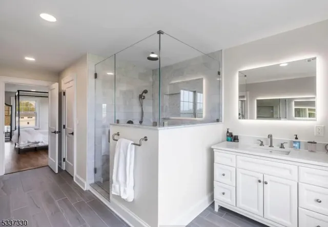 a bathroom with a double vanity sink a mirror and a bathtub