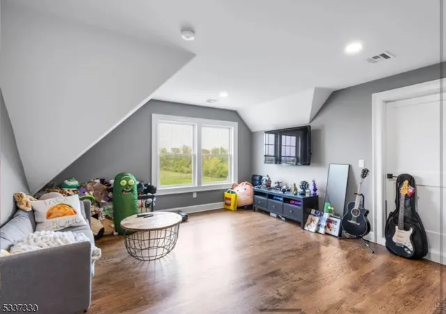 a view of a livingroom with furniture and stairs