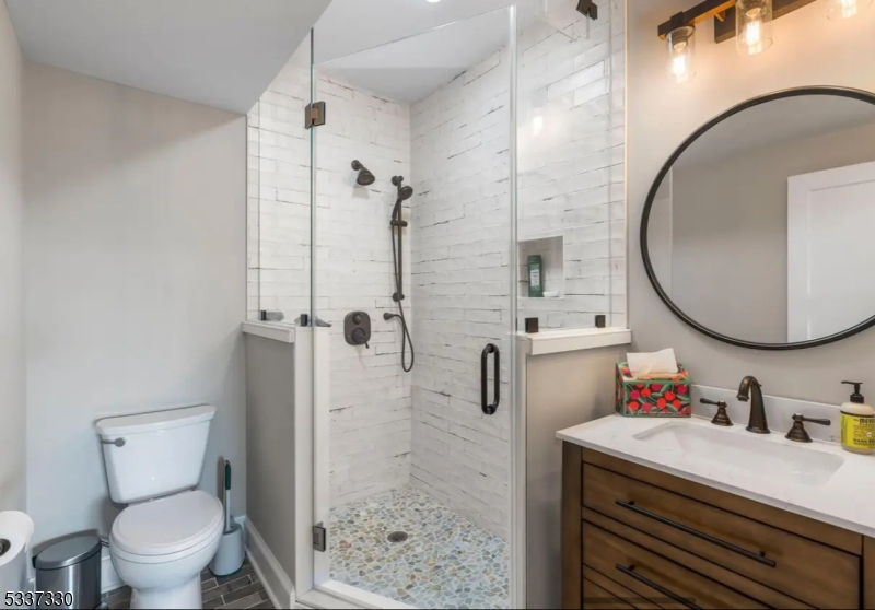 134 Hillsborough Road Hillsborough, NJ 08844 - Photo 36 of 50 a bathroom with a sink a toilet and a mirror