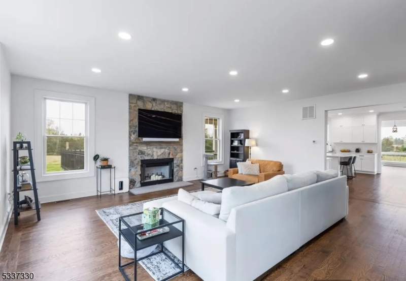 134 Hillsborough Road Hillsborough, NJ 08844 - Photo 7 of 50 a living room with furniture a fireplace a flat screen tv and large window