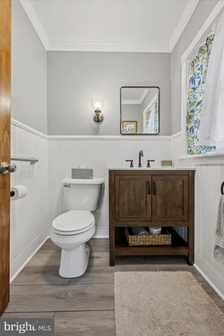 a bathroom with a sink a toilet and mirror
