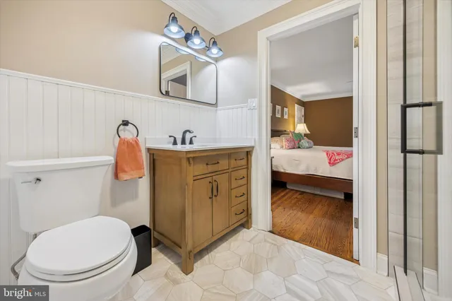 a bathroom with a sink toilet and mirror