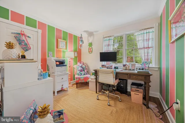 a view of a workspace with furniture and a window