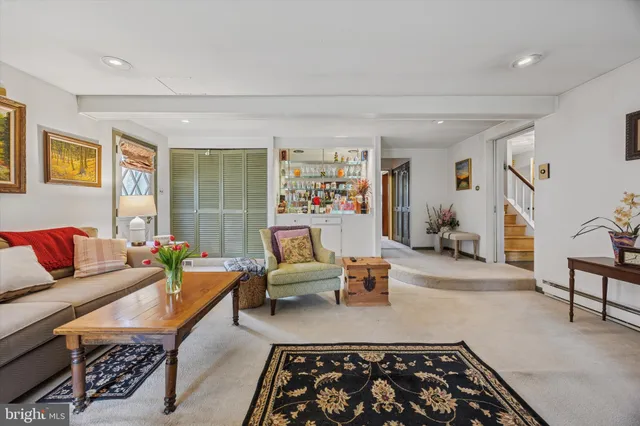 a living room with furniture and a rug