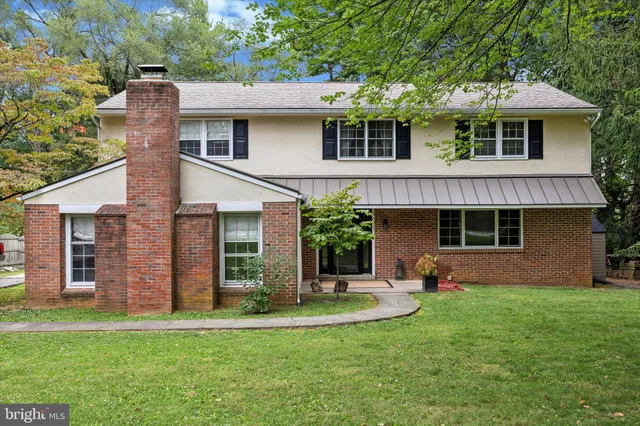 a front view of a house with a yard and a garage