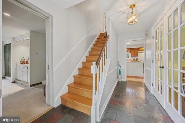 a view of a hallway with wooden floor and staircase