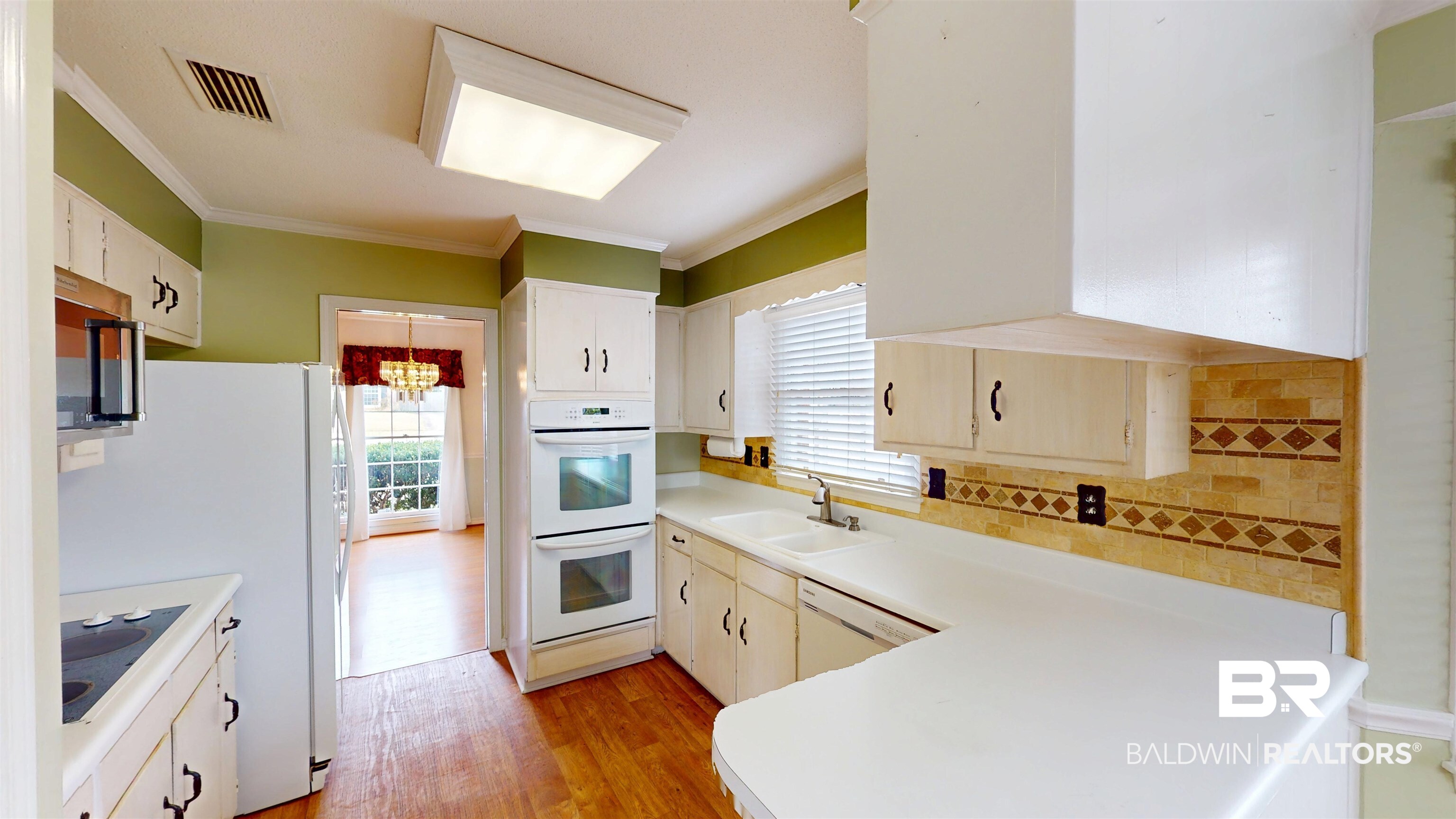 609 Burlington Court Mobile, AL 36608 - Photo 6 of 19 Kitchen with light countertops, white appliances, light wood-type flooring, healthy amount of natural light, and ornamental molding