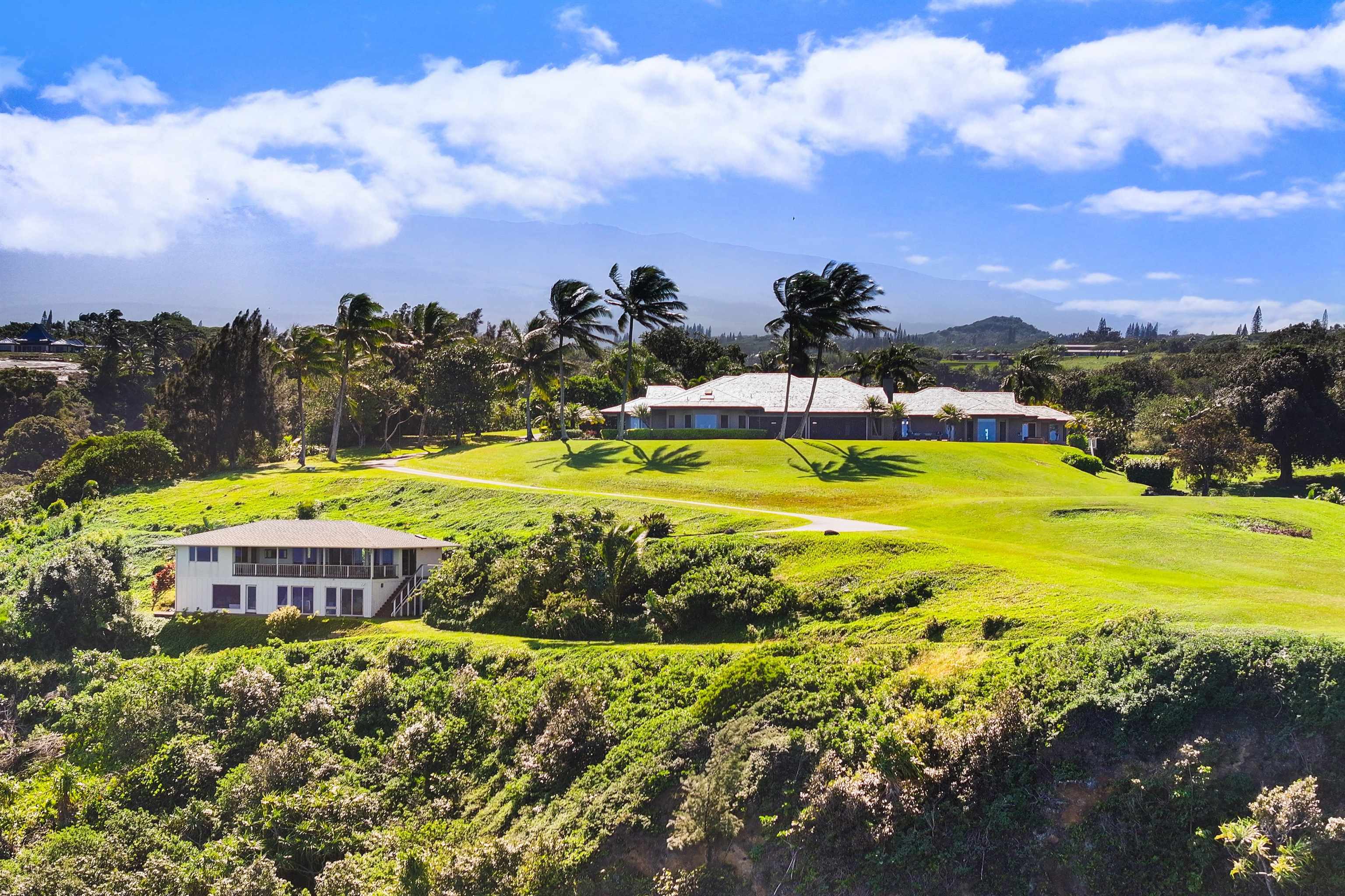 400 Mehana Road Haiku, HI 96708 - Photo 2 of 50 a view of a swimming pool with an ocean and trees in the background