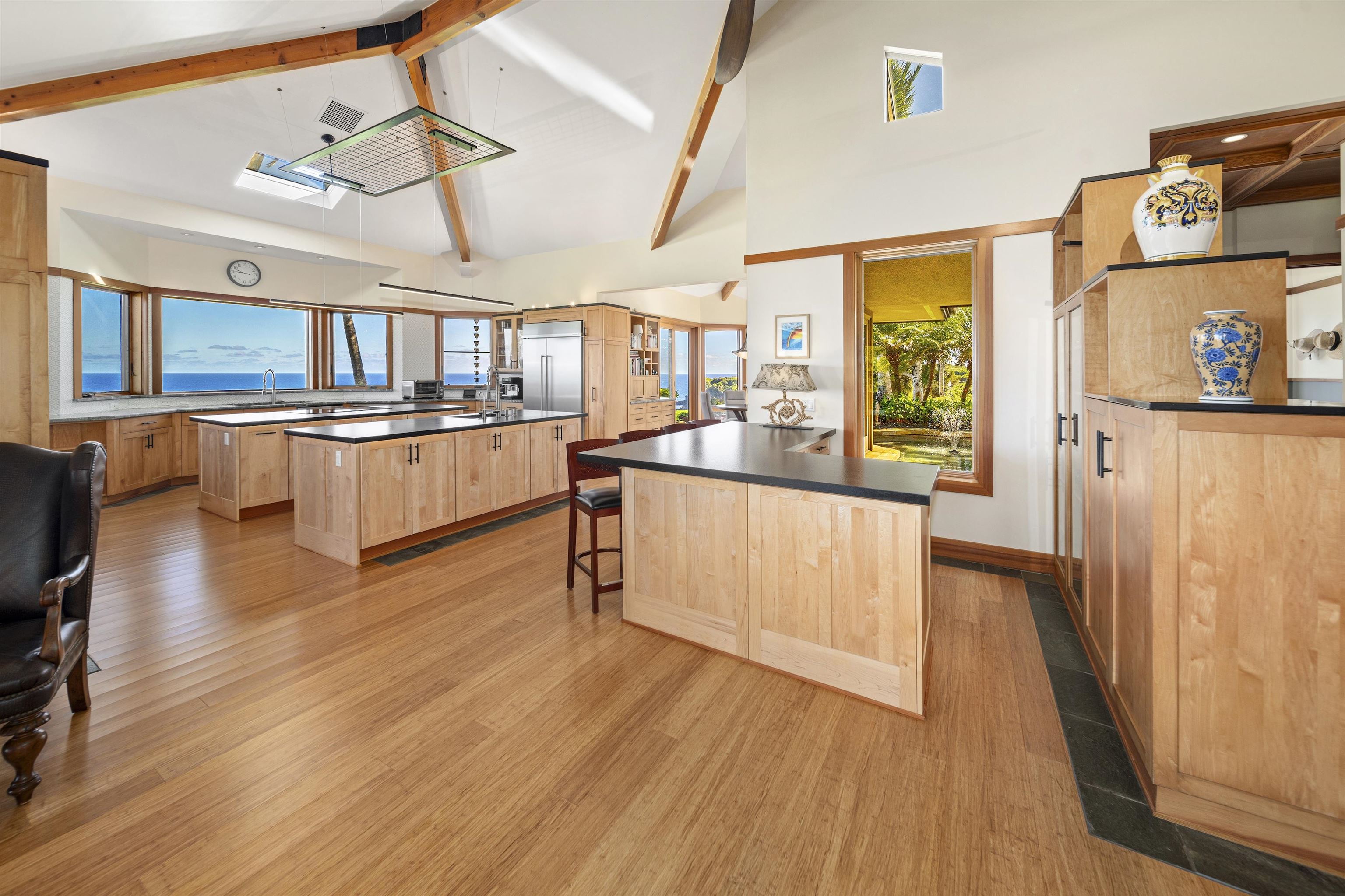 400 Mehana Road Haiku, HI 96708 - Photo 23 of 50 a large kitchen with stainless steel appliances wooden floors and large window