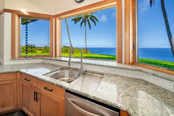 a kitchen with stainless steel appliances granite countertop a sink and a stove