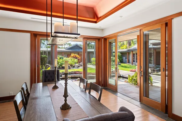 a view of a dining room with furniture large windows and wooden floor