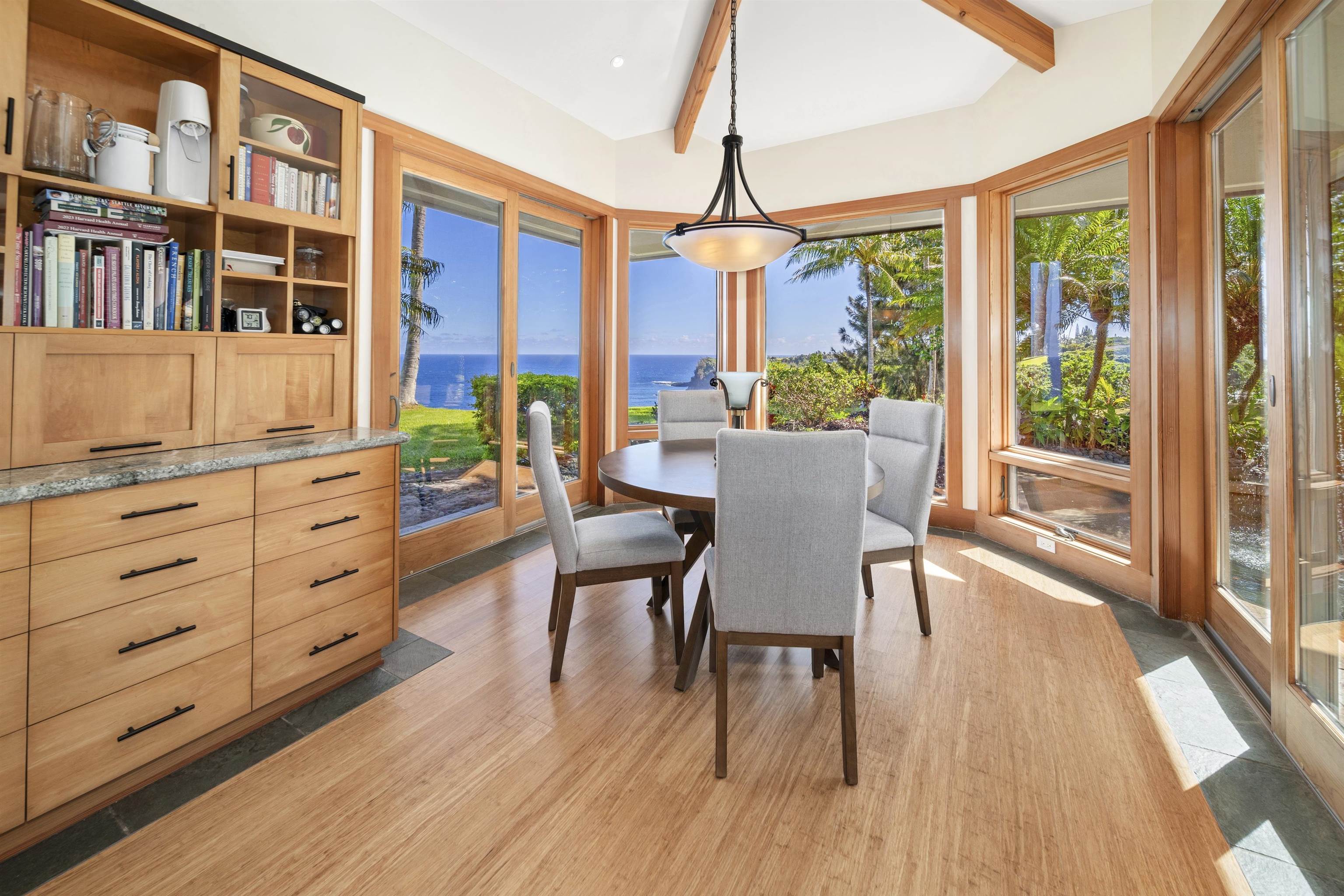 400 Mehana Road Haiku, HI 96708 - Photo 31 of 50 a view of a dining room with furniture large windows and wooden floor