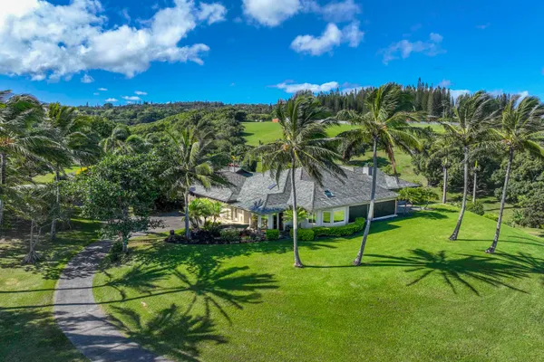 an aerial view of a house with swimming pool big yard and mountain view in back
