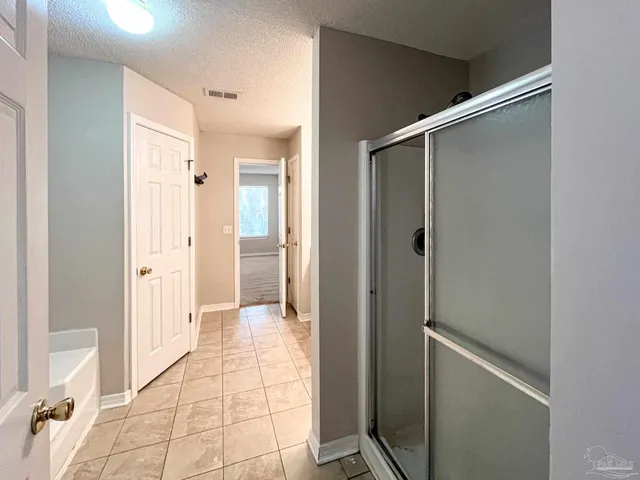 a bathroom with a shower and a glass door