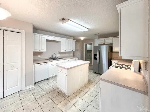 a kitchen with a sink a counter top space and appliances