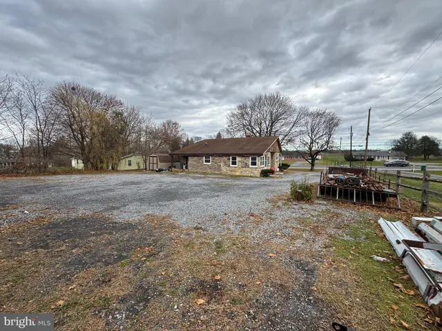 a view of yard with swimming pool and furniture