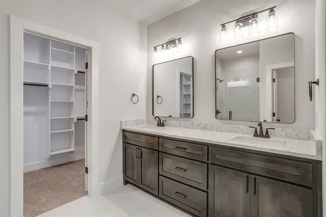 a bathroom with double sink and a mirror